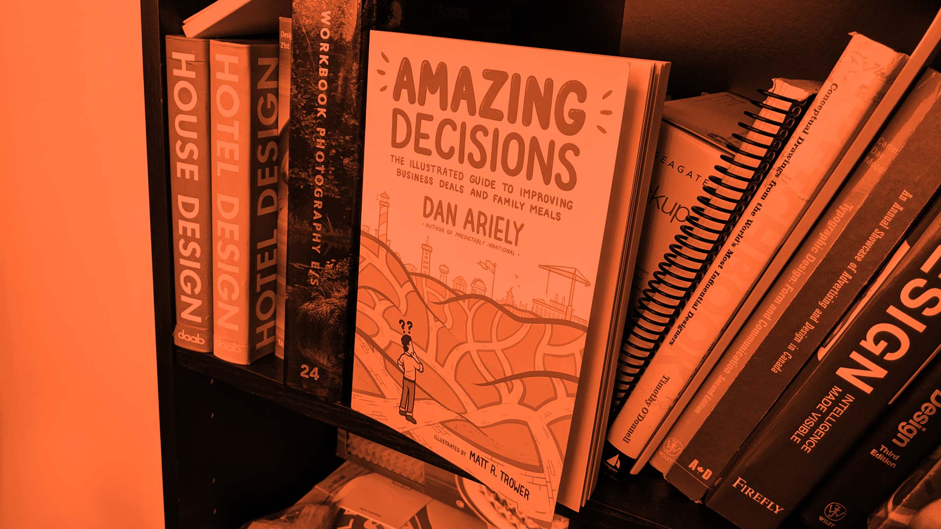 Amazing Decisions by Dan Ariely on a book shelf