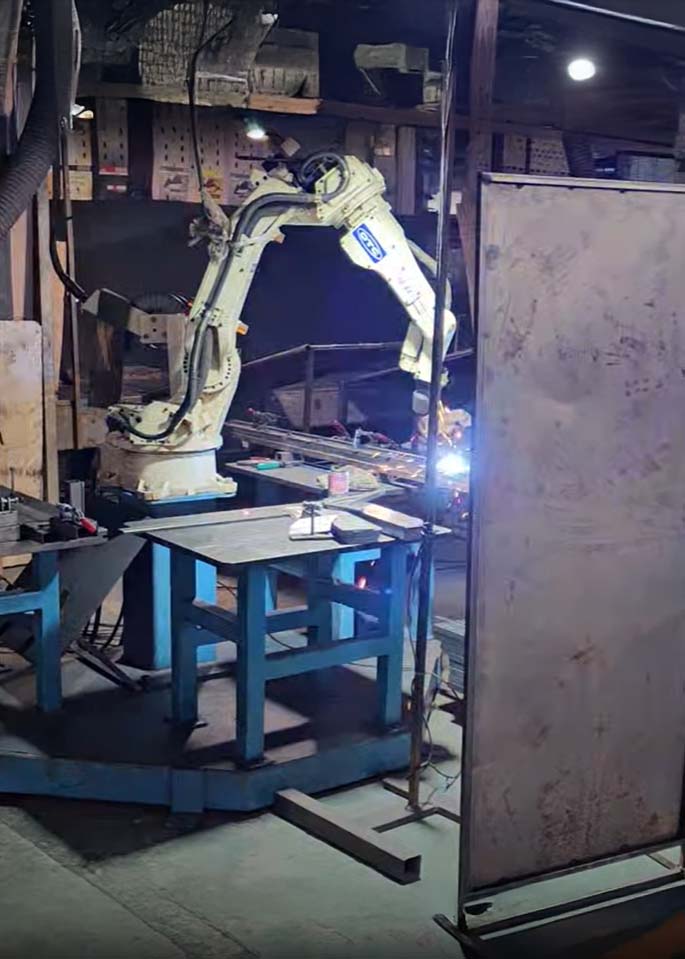 A robotic welding machine in a factory.